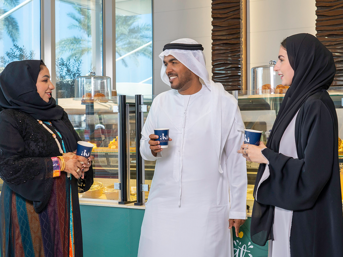 Emiratis stood by coffee stand